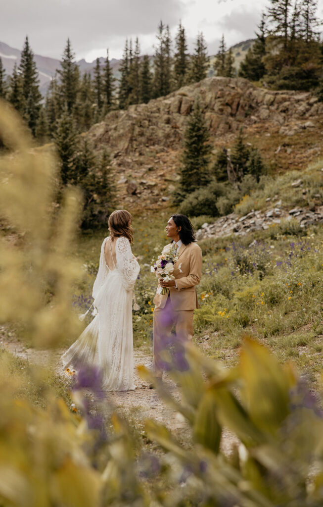 Elopement couple holding bouquet in the Colorado mountains