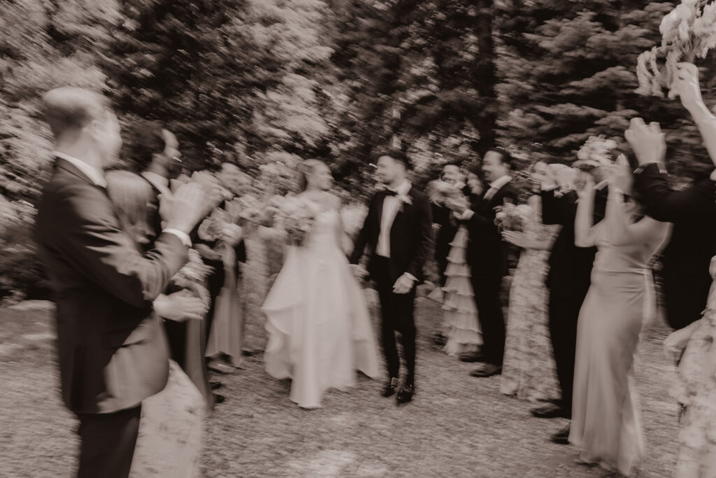 Blurry aesthetic photo of wedding party celebrating.